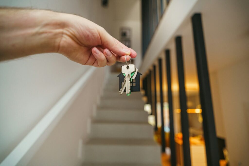A person holding keys inside a house