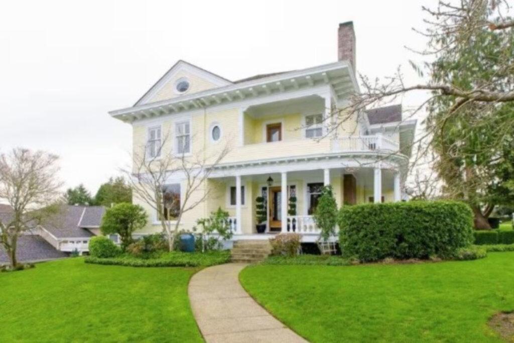 yellow and white house in green garden