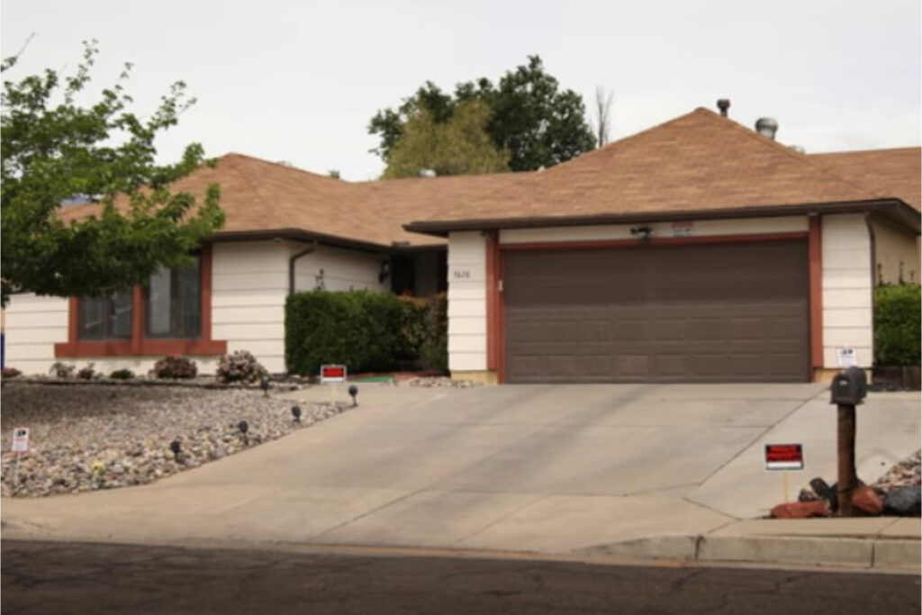 house with brown roof and garage near road