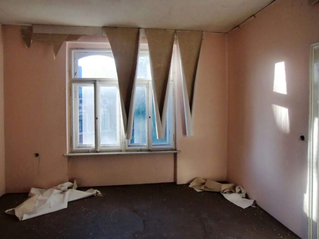 Peeling wallpaper in an empty room