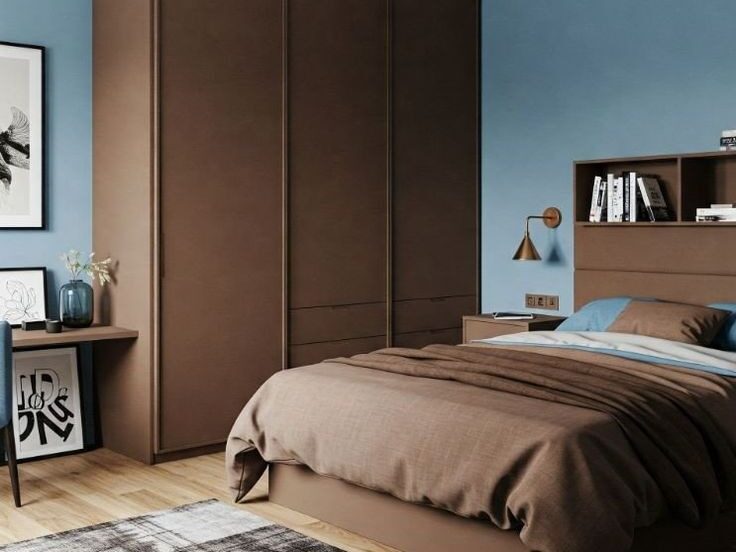 Bedroom with blue walls and bedding and brown furniture