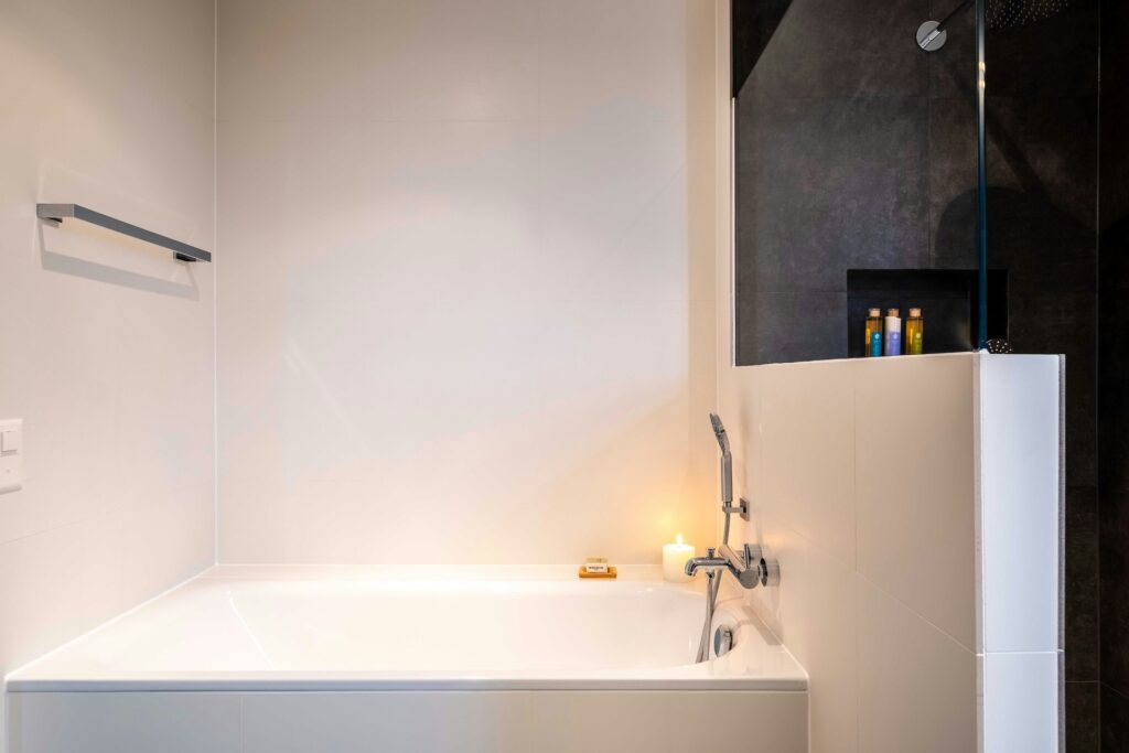 You can use the top of the half-wall as a surface for various bath items.