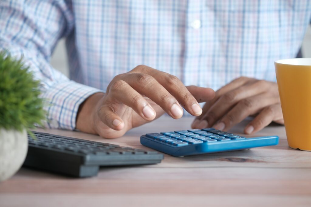 A man calculating the cost of living in Rhode Island.
